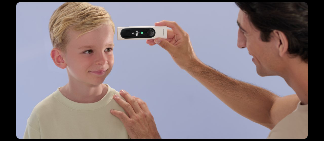 Parent checking a child's temperature with BeamO